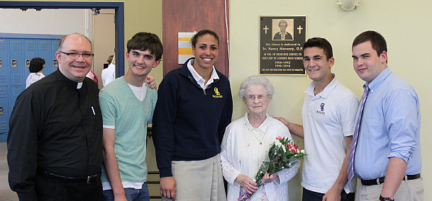 Sister Nancy and Father Lagiovane celebrated the library dedication with Student Council Representatives in 2013.