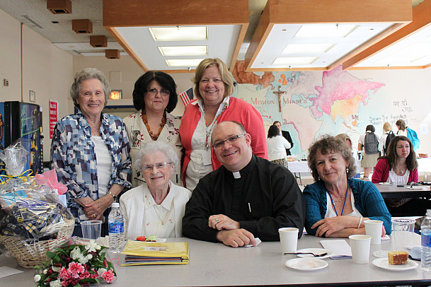 Sister Nancy celebrated her retirement at a reception in her honor following the dedication of the library. From left to right: Row 1: Si...